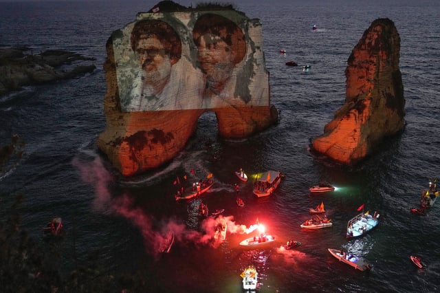 Portraits of two former Hezbollah leaders Hassan Nasrallah, right and Hashem Safieddine, left, are projected onto the landmark Raouche sea rock during an event commemorating their deaths in Israeli airstrikes nearly a year ago, in Beirut, Lebanon, Thursday, Sept. 25, 2025. (AP Photo/Hussein Malla)