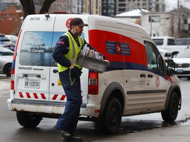 Canada Post employees deliver the mail in Ottawa.