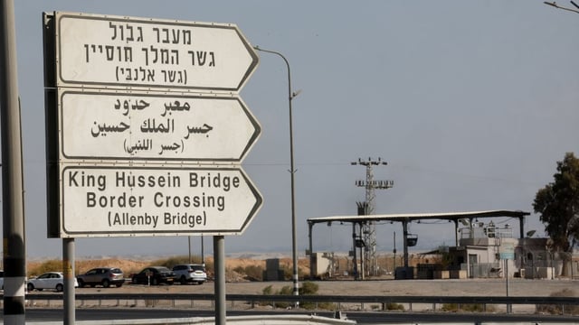 Road signs point to the currently closed Allenby Bridge Crossing between West Bank and Jordan, in the Israeli-occupied West Bank on Sept. 24. Israel is reopening the crossing to passenger traffic only starting Friday morning, the Israeli Airports Authority said on Thursday.