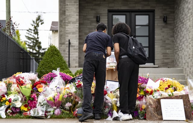 Teenagers light candles and pay their respects at the memorial site for classmate Nooran Rezayi, who was killed on Sunday afternoon after police responded to a report of a group of armed people in a quiet suburban neighbourhood in Longueuil, Que., south of Montreal on Thursday, September 25, 2025.  THE CANADIAN PRESS/Christinne Muschi
