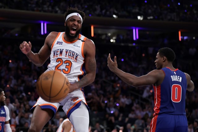 New York Knicks center Mitchell Robinson (23) reacts after dunking the ball in front of Detroit Pistons center Jalen Duren (0) in the first half during Game 5 in an NBA basketball first-round playoff series Tuesday, April 29, 2025, in New York. (AP Photo/Adam Hunger)