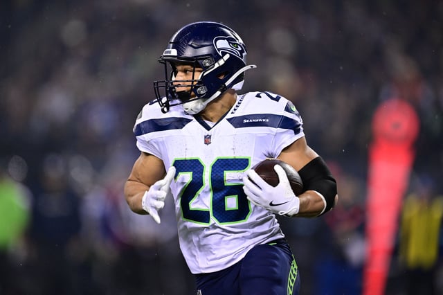 Dec 26, 2024; Chicago, Illinois, USA; Seattle Seahawks running back Zach Charbonnet (26) runs the ball against the Chicago Bears during the first quarter at Soldier Field. Mandatory Credit: Daniel Bartel-Imagn Images/File photo