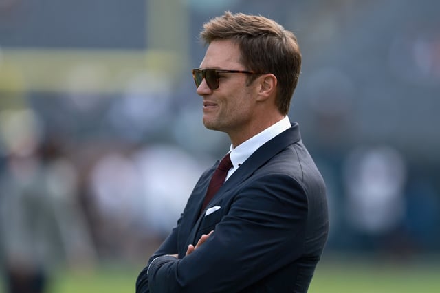 CHICAGO, ILLINOIS - SEPTEMBER 21: Fox Sport analyst Tom Brady looks on before the game between the Dallas Cowboys and the Chicago Bears at Soldier Field on September 21, 2025 in Chicago, Illinois. (Photo by Geoff Stellfox/Getty Images)