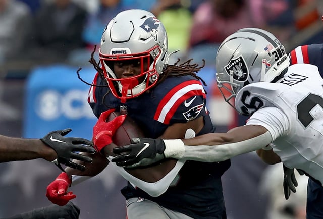 Foxboro, MA - New England Patriots running back Rhamondre Stevenson tries to break past Las Vegas Raiders cornerback Kyu Blu Kelly during the second quarter of the game at Gillette Stadium. (Nancy Lane/Boston Herald)