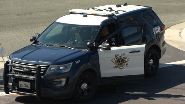 File image of a San Jose Police Department (SJPD) officer and vehicle.