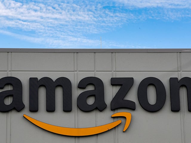 FILE PHOTO: The Amazon logo is seen outside its JFK8 distribution center in Staten Island, New York, U.S. November 25, 2020. REUTERS/Brendan McDermid/File Photo