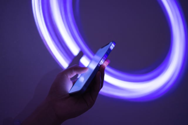 Using smartphone on holographic background