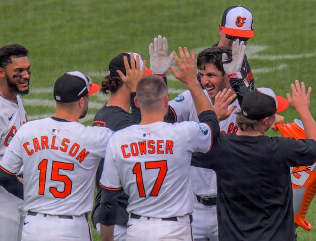 Facing camera, Baltimore Orioles batter Dylan Beavers celebrates with teammates including  left fielder Dylan Carlson and center fielder Colton Cowser after his clutch solo home run cleared the fence against the Tampa Bay Rays with the game tied in the bottom of the ninth inning of the final home major league baseball game of the season at Oriole Park at Camden Yards. Baltimore came from behind to edge Tampa Bay, 6-5. (Karl Merton Ferron/Staff)