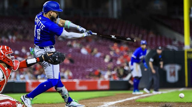 Sep 3, 2025; Cincinnati, Ohio, USA; Toronto Blue Jays shortstop Bo Bichette (11) hits a fielder’s choice RBI in the eighth inning against the Cincinnati Reds at Great American Ball Park. Mandatory Credit: Katie Stratman-Imagn Images