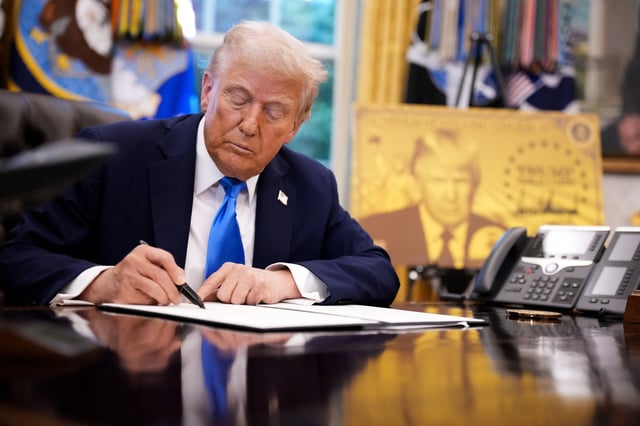 President Donald Trump signs an executive order in the Oval Office at the White House on Sept. 19, 2025, in Washington, D.C., in which he introduced a $100,000 fee for H-1B visas. (Andrew Harnik/Getty)