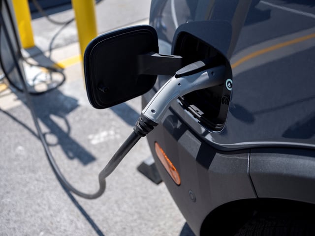 New Amazon EV vans powered by Rivian are parked at charging stations at the Amazon Logistics Facility in Chicago. Amazon and Rivian unveil their final custom Electric Delivery Vehicles (EDV) to begin using them for customer deliveries, in Chicago, Illinois, U.S. July 21, 2022.