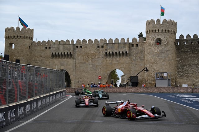Ferrari's Monegasque driver Charles Leclerc (R) and Ferrari's British driver Lewis Hamilton (C) compete during the Formula One Azerbaijan Grand Prix at the Baku City Circuit in Baku on September 21, 2025.