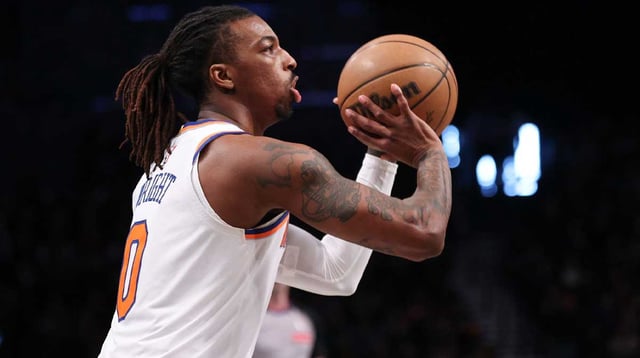 Apr 13, 2025; Brooklyn, New York, USA; New York Knicks guard Delon Wright (0) shoots the ball during the first half against the Brooklyn Nets at Barclays Center. Mandatory Credit: Vincent Carchietta-Imagn Images