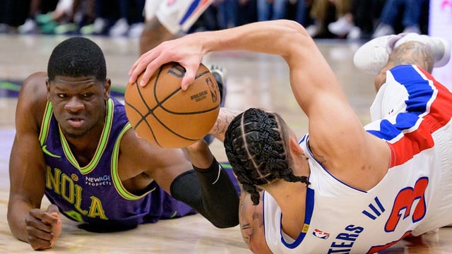 Mar 17, 2025; New Orleans, Louisiana, USA; New Orleans Pelicans center Mo Bamba (4) and Detroit Pistons forward Lindy Waters III (43) fall to the court chasing a ball during the second half at Smoothie King Center. Mandatory Credit: Matthew Hinton-Imagn Images