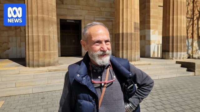 Man standing with hand on hip at the front of the Adelaide Magistrates Court