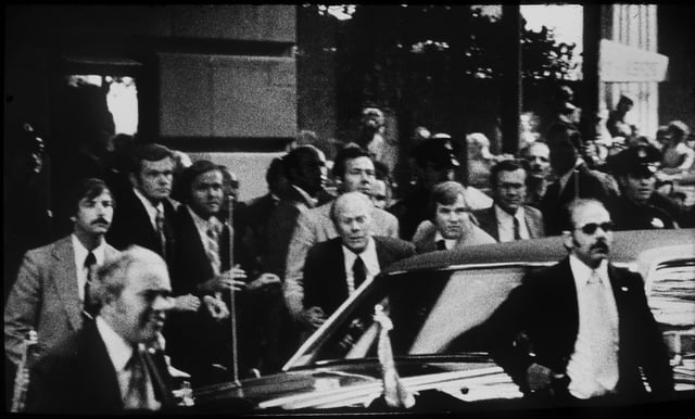 This Sept. 22, 1975 file photo shows Secret Service agents grabbing President Gerald Ford to push him in the armor protected limo outside the St. Francis Hotel after a shot was fired. 