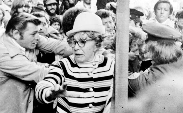 Oliver Sipple, left, lunges for Sara Jane Moore, right, behind pole, in this Sept. 22, 1975 file photo, just after a shot was fired in the direction of then-President Gerald Ford as he left the St. Francis Hotel in San Francisco. 