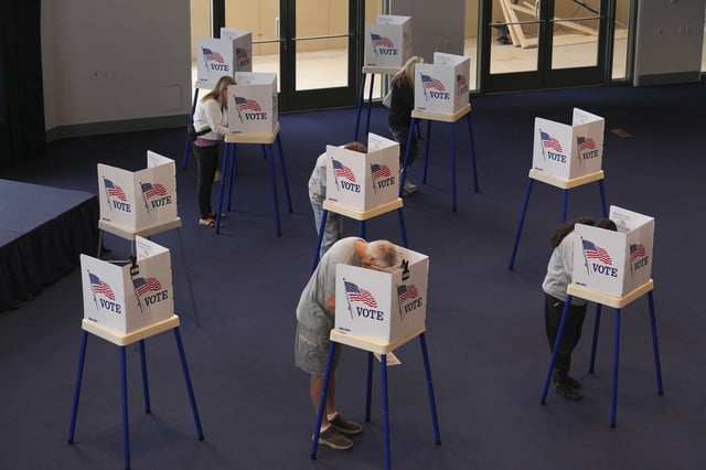 Voters work on their ballots at a polling place at the Ronald Reagan Presidential Library on Nov. 5, 2024, in Simi Valley, Calif.