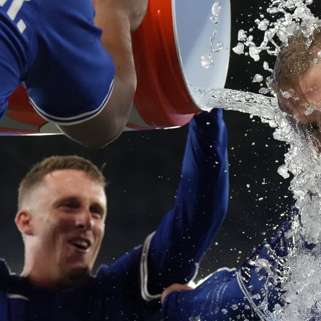 Toronto Blue Jays' Daulton Varsho (right) is doused after defeating the Boston Red Sox in  MLB baseball action in Toronto on Thursday September 25, 2025. THE CANADIAN PRESS/Chris Young