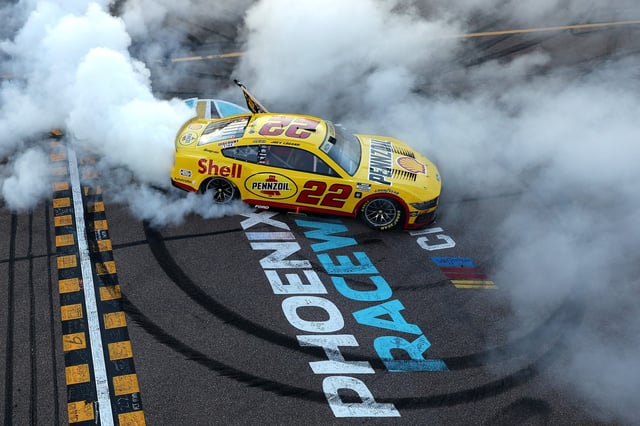 Joey Logano, driver of the #22 Shell Pennzoil Ford, celebrates with a burnout after winning the 2024 NASCAR Cup Series Championship Race at Phoenix Raceway. Image: Meg Oliphant/Getty Images