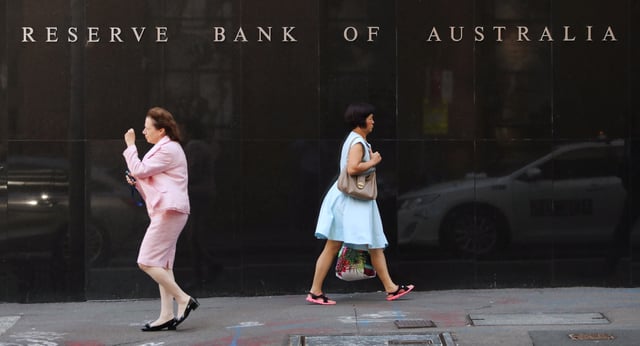 Two women walk next to the Reserve Bank of Australia headquarters in central Sydney, Australia February 6, 2018. REUTERS/Daniel Munoz/File Photo