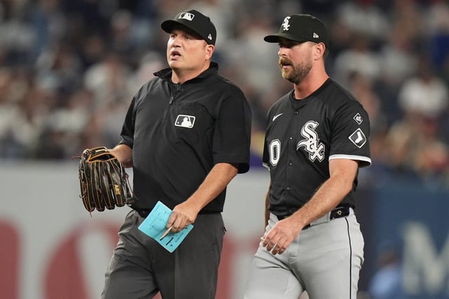 Umpire Dan Bellino inspects the glove of White Sox reliever Tyler Gilbert before he pitches in the fifth inning against the Yankees on Thursday, Sept. 25, 2025, in New York. Gilbert had to switch gloves before pitching. (Frank Franklin II/AP)