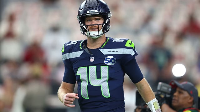 Sep 25, 2025; Glendale, Arizona, USA; Seattle Seahawks quarterback Sam Darnold (14) looks on before the game against the Arizona Cardinals at State Farm Stadium. Mandatory Credit: Mark J. Rebilas-Imagn Images