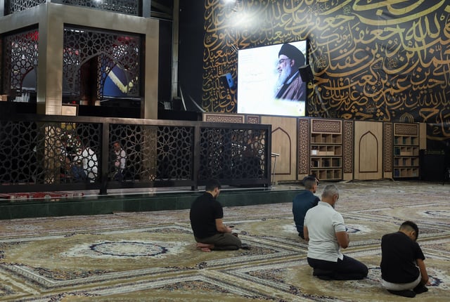 People pray at the burial site of late Hezbollah leader Hassan Nasrallah ahead of the first anniversary of his assassination, on the outskirts of Beirut, Lebanon September 24, 2025. REUTERS/Mohamed Azakir
