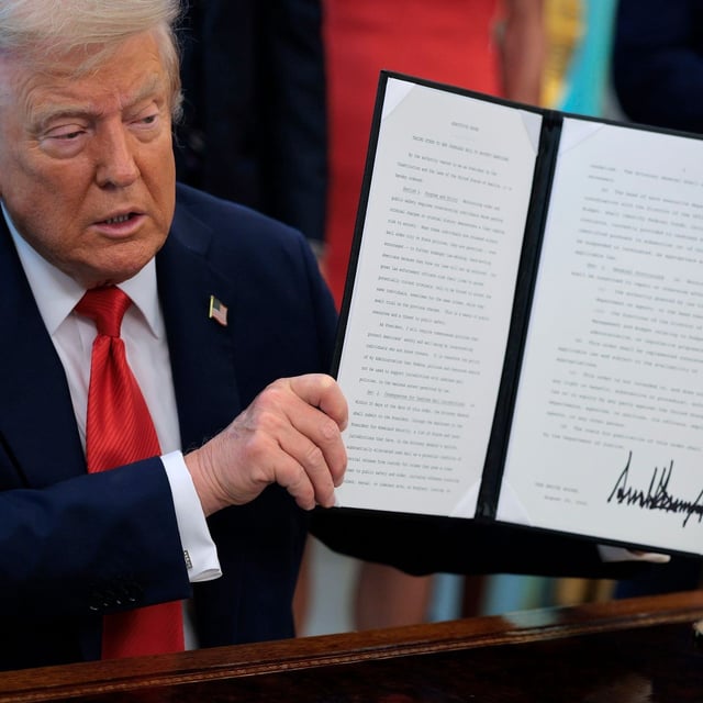 WASHINGTON, DC - AUGUST 25: U.S. President Donald Trump signs executive orders in the Oval Office at the White House on August 25, 2025 in Washington, DC. Furthering his federal takeover of the capital city’s law enforcement, Trump signed orders ending cashless bail in the District of Columbia, mandating prosecution for people who desecrate the American flag, including by burning it, and other orders. (Photo by Chip Somodevilla/Getty Images)
