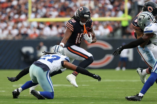 Bears wide receiver Luther Burden III tries to leap Cowboys defensive back Reddy Steward in the third quarter Sept. 21, 2025, at Soldier Field. (Brian Cassella/Chicago Tribune)