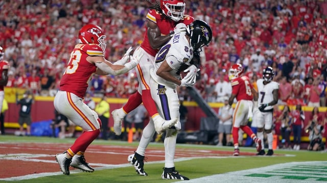 Baltimore Ravens tight end Isaiah Likely, left, catches a pass with his toe out of bounds as Kansas City Chiefs linebacker Nick Bolton (32) and linebacker Drue Tranquill (23) defend as time time expires in the second half of an NFL football game Thursday, Sept. 5, 2024, in Kansas City, Mo. The Chiefs won 27-20.(AP Photo/Ed Zurga)