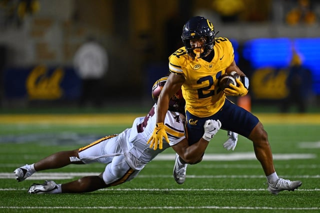 California Golden Bears running back Jayden Parker (24) is tackled by Minnesota Golden Gophers defensive back Za’Quan Bryan (4) in the second quarter of their game at Memorial Stadium in Berkeley, Calif., on Saturday, Sept. 13, 2025. (Jose Carlos Fajardo/Bay Area News Group)