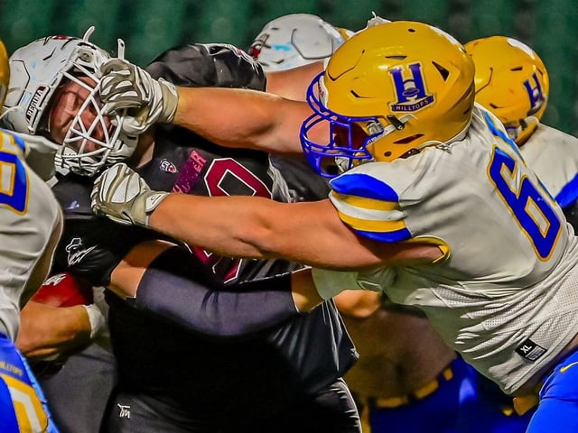 Saskatoon Hilltops defensive lineman Ryan Adamko and Regina Thunder offensive lineman Andrew Barager mix it up during a Prairie Football Conference game, won 18-15 by the hometown Hilltops on Sept. 6.