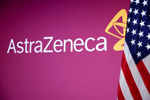 A U.S. flag stands next to the AstraZeneca logo during a signing event for documents related to a manufacturing site investment at the Meridian International Center in Washington, D.C., July 21, 2025. REUTERS/Umit Bektas/File Photo