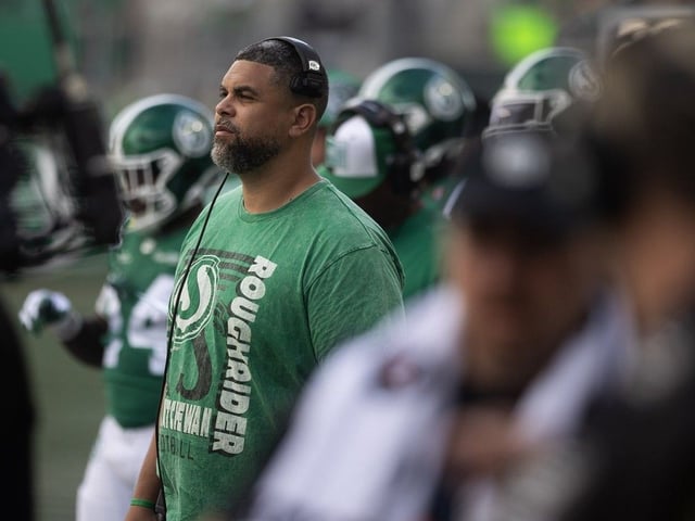 Saskatchewan Roughriders head coach Corey Mace on the Mosaic Stadium sideline during his CFL team's 2025 Labour Day Classic against the Winnipeg Blue Bombers.