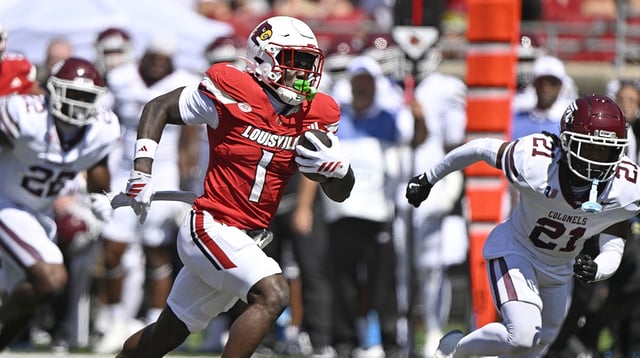 Aug 30, 2025; Louisville, Kentucky, USA; Louisville Cardinals running back Isaac Brown (1) runs the ball against Eastern Kentucky Colonels defensive back Rishad Hence (21) during the first quarter at L&N Federal Credit Union Stadium. Mandatory Credit: Jamie Rhodes-Imagn Images