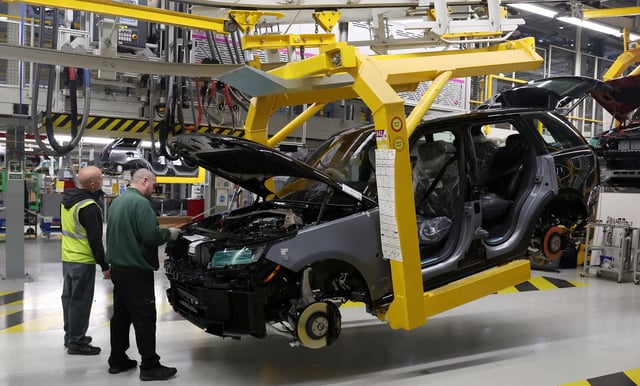A member of staff works on the production line at Jaguar Land Rover’s factory in Solihull, Britain, December 15, 2022. REUTERS/Phil Noble/File Photo