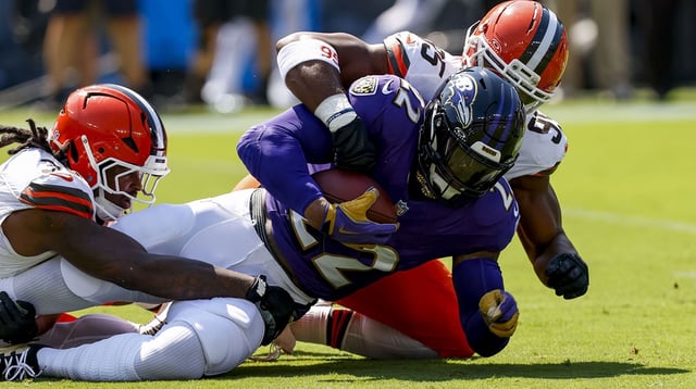 Sep 14, 2025; Baltimore, Maryland, USA; Baltimore Ravens running back Derrick Henry (22) is tackled by Cleveland Browns defensive end Myles Garrett (95) during the first quarter at M&T Bank Stadium. Mandatory Credit: Peter Casey-Imagn Images