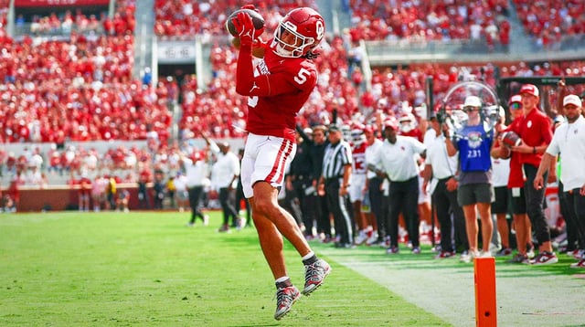 Sep 20, 2025; Norman, Oklahoma, USA; Oklahoma Sooners wide receiver Isaiah Sategna III (5) is left uncovered and catches a touchdown pass during the first half against the Auburn Tigers at Gaylord Family-Oklahoma Memorial Stadium. Mandatory Credit: Kevin Jairaj-Imagn Images