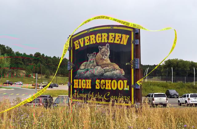 Crime scene tape blows in the wind outside Evergreen High School on Sept. 11, 2025 in Evergreen, CO.