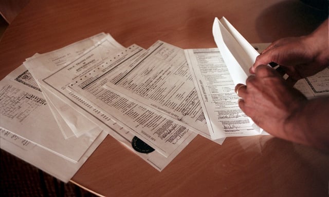H-1B visa application documents are shown. (Meri Simon/Bay Area News Group/TNS)