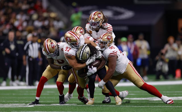 NEW ORLEANS, LA - SEPTEMBER 14: Nick Bosa #97 and Alfred Collins #95 of the San Francisco 49ers tackle Alvin Kamara #41 of the New Orleans Saints during the game at the Caesars Superdome on September 14, 2025 in New Orleans, Louisiana. The 49ers defeated the Saints 26-21. (Photo by Michael Zagaris/San Francisco 49ers/Getty Images)