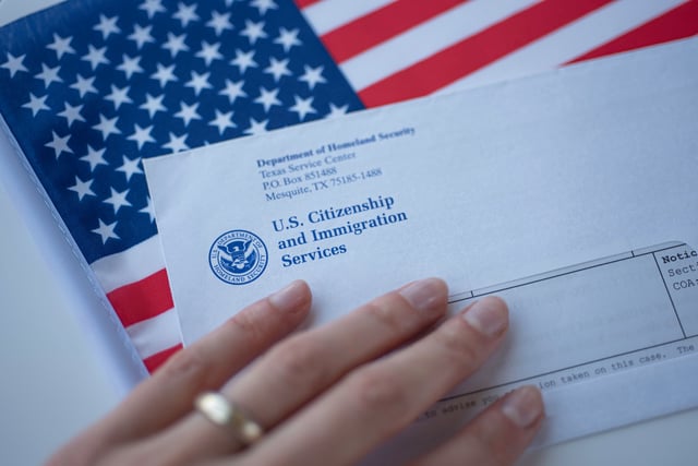 Letter from USCIS and and an American flag pictured in Washington, DC on September, 16, 2019.