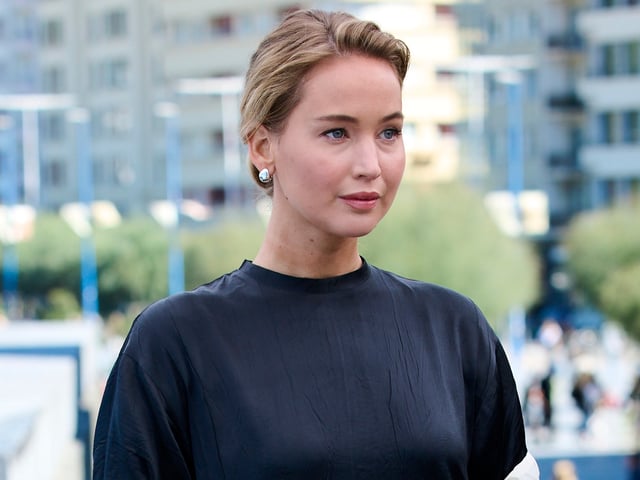 Jennifer Lawrence attended a film festival in spain wearing a T-shirt, pants, and a dress-like train