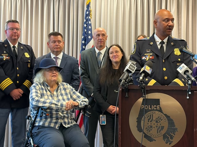 Baltimore County Police Chief Robert McCullough said detectives, using DNA analysis, identified a suspect in the cold case homicide of Samuel Allen. Allen, 59, was killed in his home during a burglary attempt. His daughter, Ann Allen, seated, attended Friday's press conference. (Luke Parker/Staff)