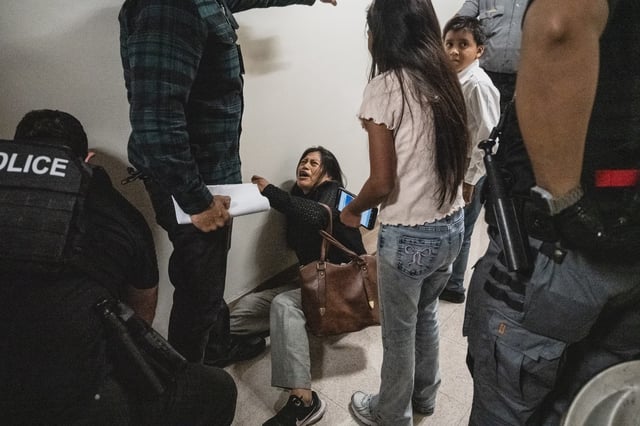 The wife of a detained immigrant seen on the floor in a hallway outside the immigration courthouse at 26 Federal Plaza in Manhattan. Viral video shows a federal agent shoving the woman to the ground on Sept. 25, 2025.