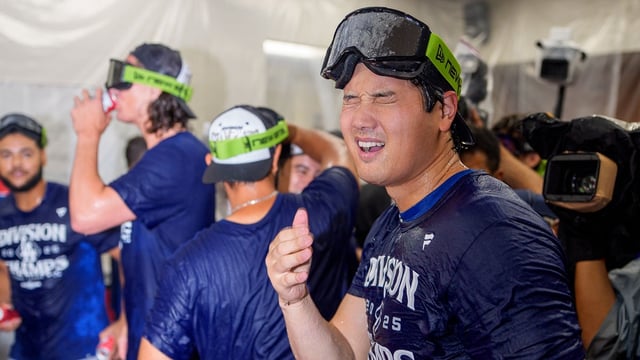 Sep 25, 2025; Phoenix, Arizona, USA; Los Angeles Dodgers designated hitter Shohei Ohtani (17) reacts after getting beer in his eyes as he celebrates with his team after winning the National League West championship follow a game against the Arizona Diamondbacks at Chase Field. Mandatory Credit: Allan Henry-Imagn Images