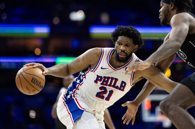 76ers center Joel Embiid controls the ball against Nets center Day'Ron Sharpe during the third quarter at Wells Fargo Center in Philadelphia on Feb. 22, 2025.