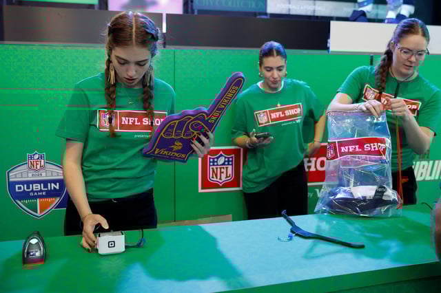Workers in a pop-up American football NFL shop check out items at the register ahead of the NFL's first-ever Irish regular-season game with Pittsburgh Steelers versus Minnesota Vikings to play in Croke park, in Dublin, Ireland September 26, 2025. REUTERS/Clodagh Kilcoyne