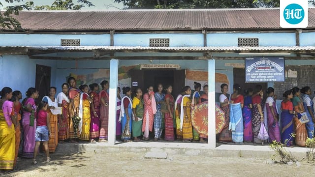 People stand in a queue to cast their votes during the Bodoland Territorial Council (BTC) elections at a polling station at Urahiloga village of Sonitpur district, Assam, on Sept. 22. (PTI)